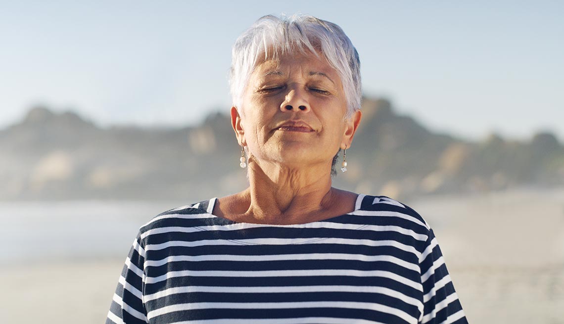 woman outdoors breathing deeply with closed eyes
