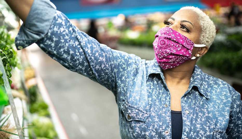 Woman with face mask shopping at supermarket