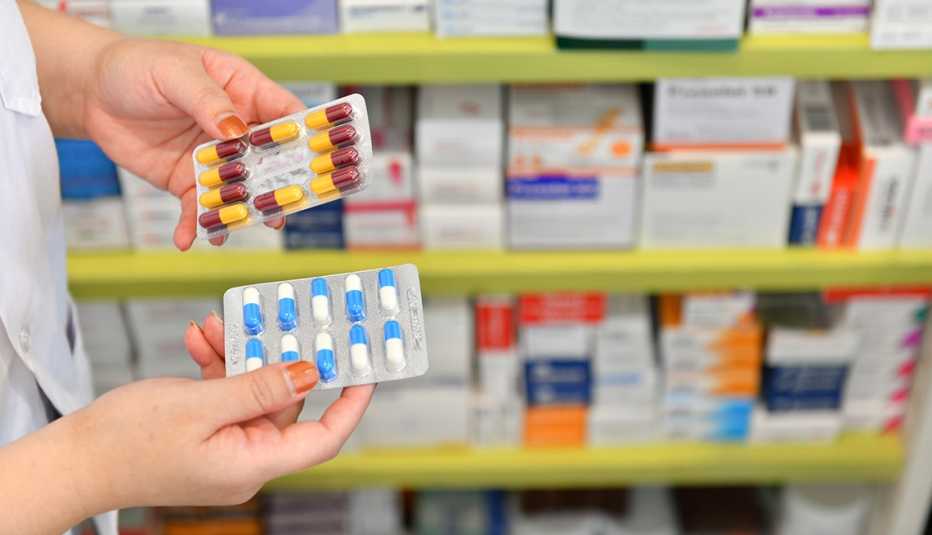 pharmacist holding medicine capsule pack at the pharmacy drugstore pharmacist holding medicine capsule pack at the pharmacy drugstore