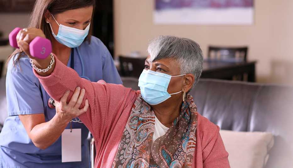masked physical therapy patient and health care provider
