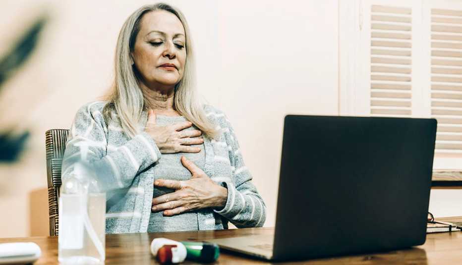 woman sitting at a table holding her breath