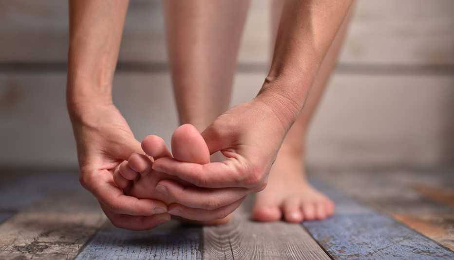 woman massaging her feet woman massaging her feet