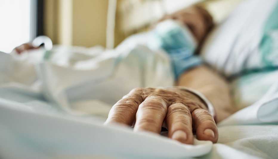 woman wearing mask in hospital bed