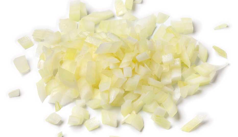 heap of chopped raw white or yellow onions isolated on white background