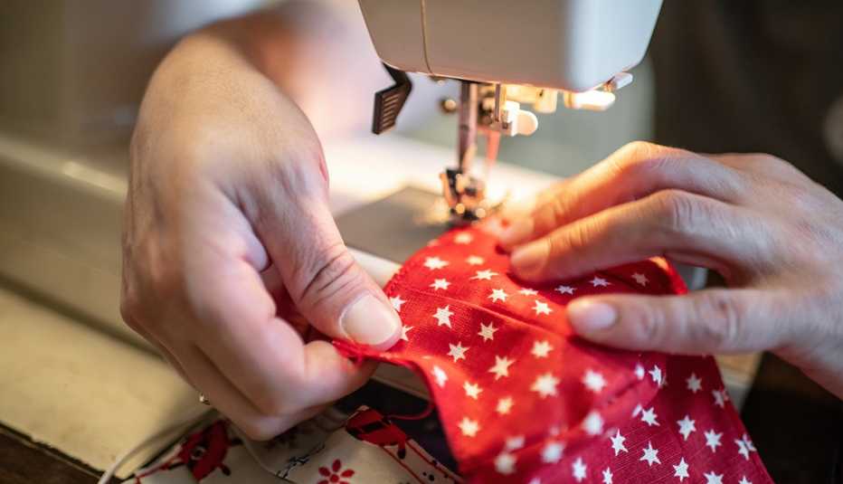 close up of person sewing a face mask