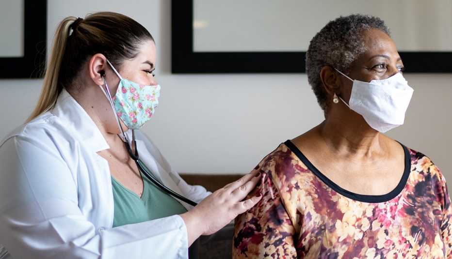 doctor using stethoscope to hear a patient heartbeat