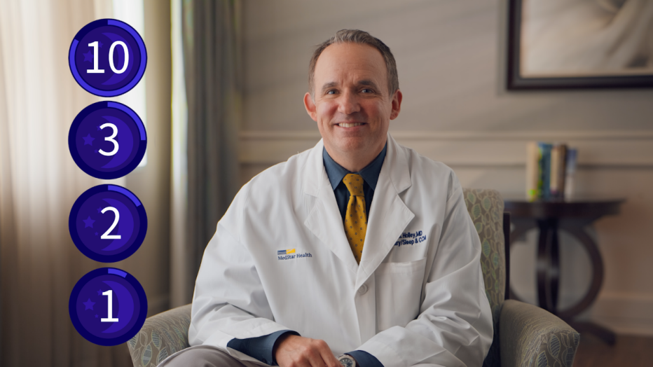 a smiling man wearing a lab coat