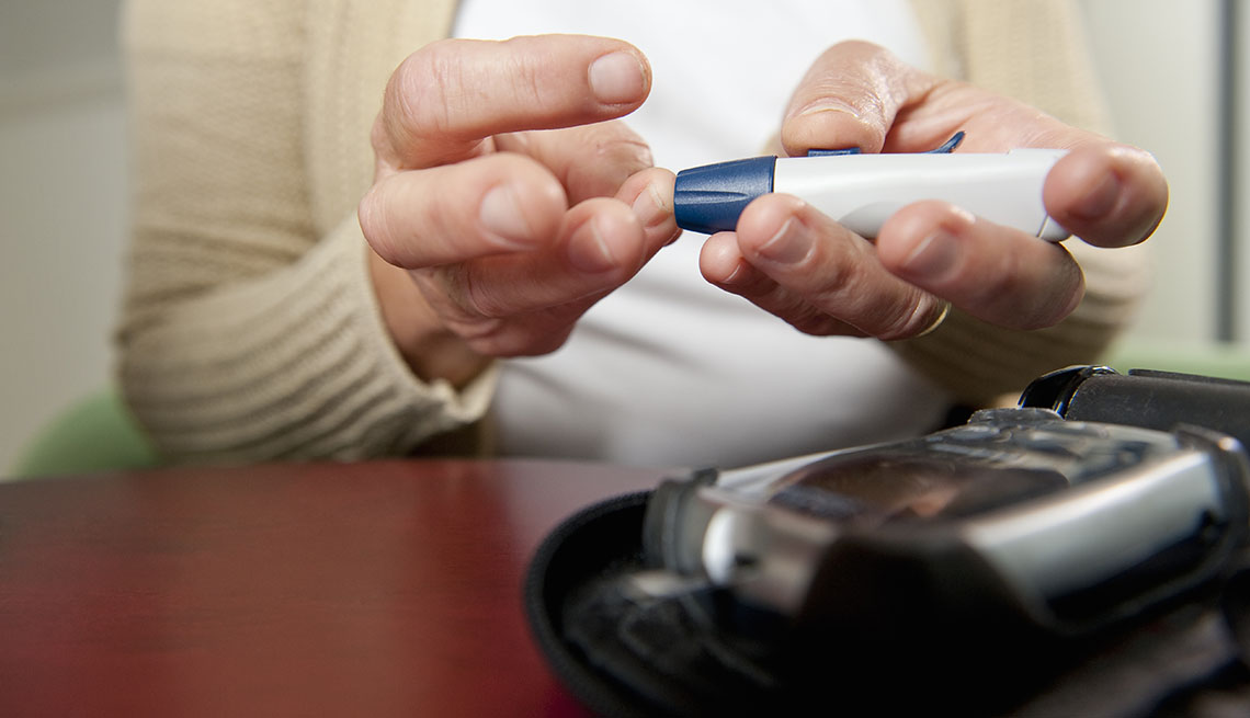 woman using a diabetes testing kit