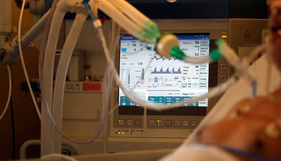 A picture shows a monitor with a breathing machine on an intubated and sedated patient infected with COVID-19. A picture shows a monitor with a breathing machine on an intubated and sedated patient infected with COVID-19.