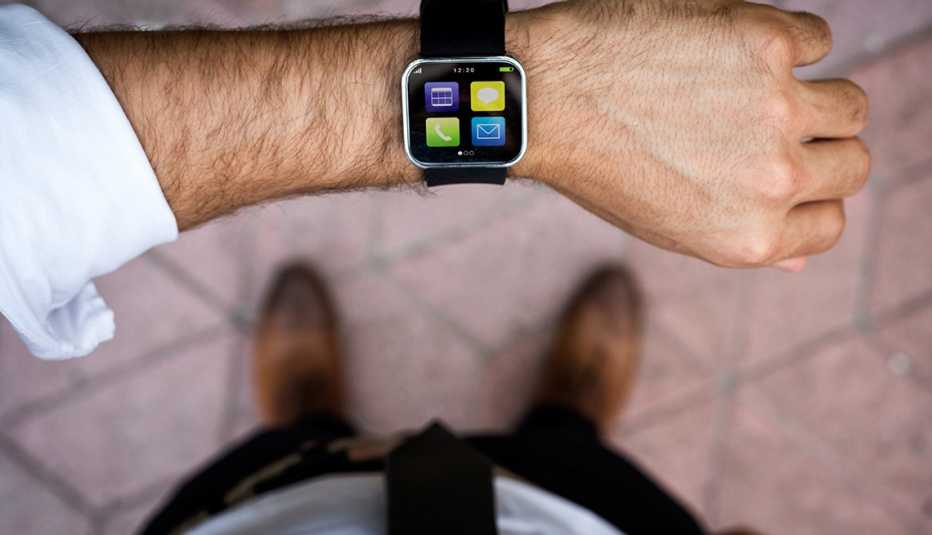 above view of a smartwatch on man's arm icons are visible on the screen