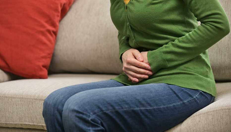 woman holding her stomach in pain