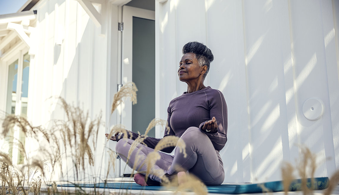 woman meditating in her backyard