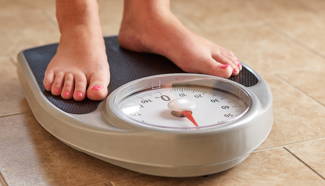 Woman's feet on a bathroom scale