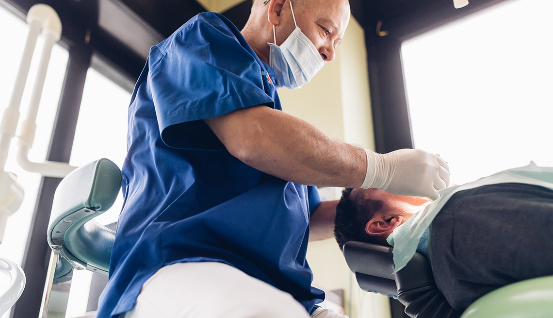 Dentist looking at patient's teeth