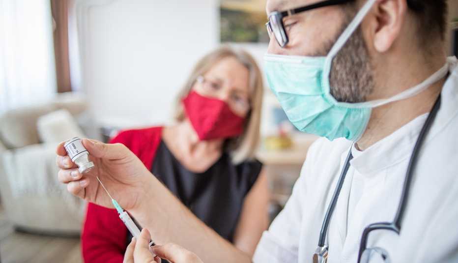 woman in a doctor's office about to get her vaccine booster woman in a doctor's office about to get her vaccine booster