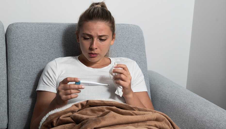 Young woman checking temperature