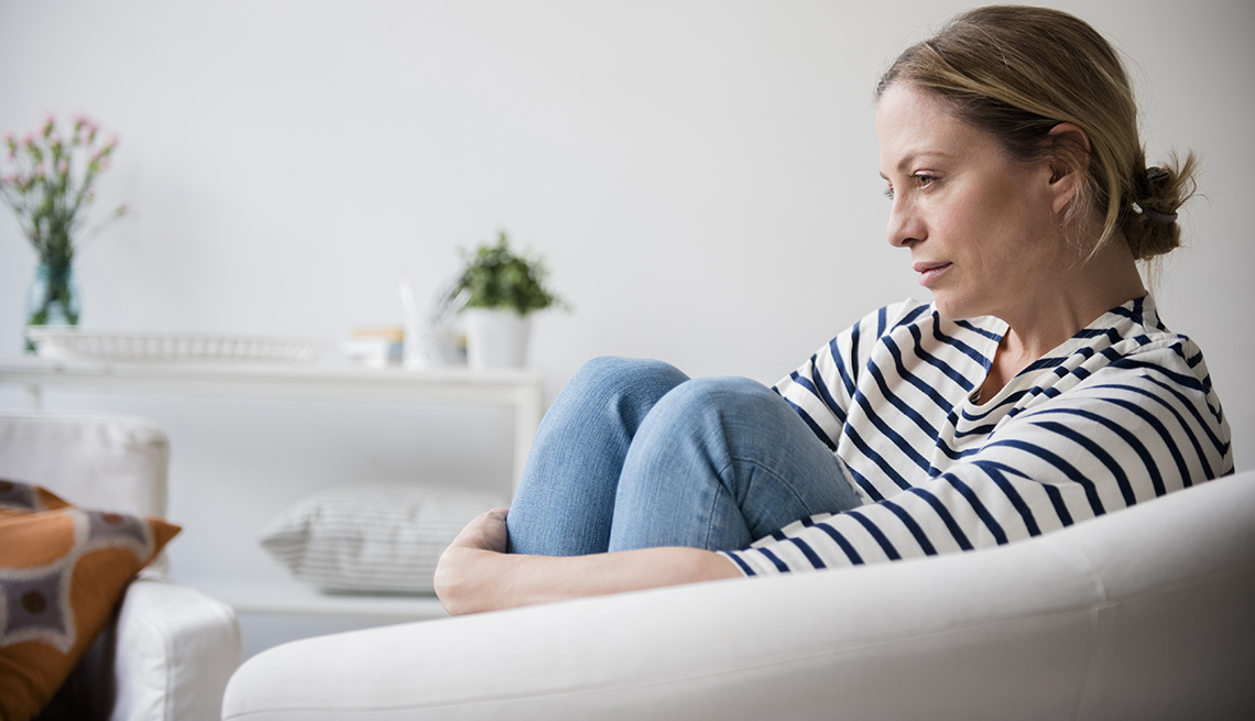 Concerned woman sitting in chair