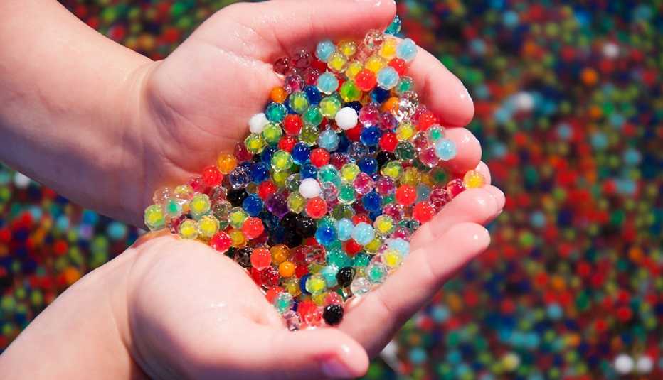 Hands holding expanded water beads Parents and caregivers are being warned not to give water beads to children.