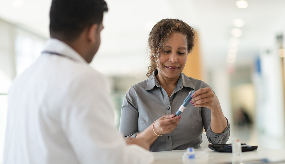 Doctor and patient discussing insulin pen