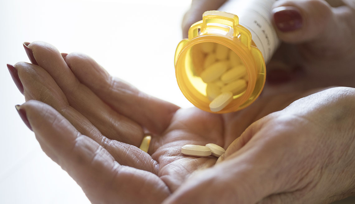 Pill bottle and hands