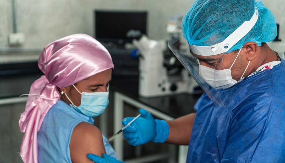 Female cancer patient getting a COVID vaccine.