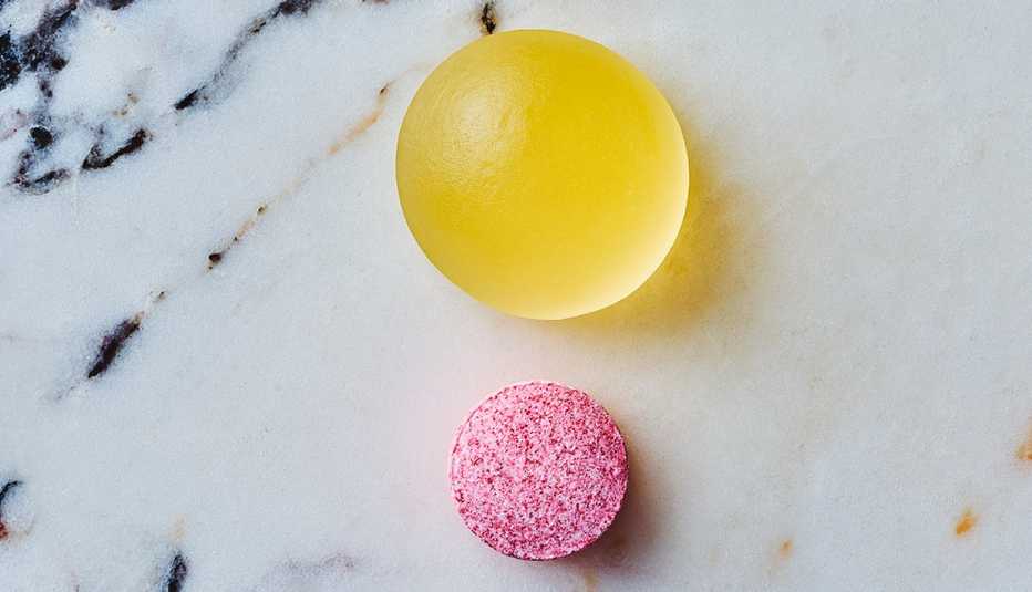 photo of a gold colored chewable vitamin d three supplement and a dissolvable vitamin b twelve supplement 