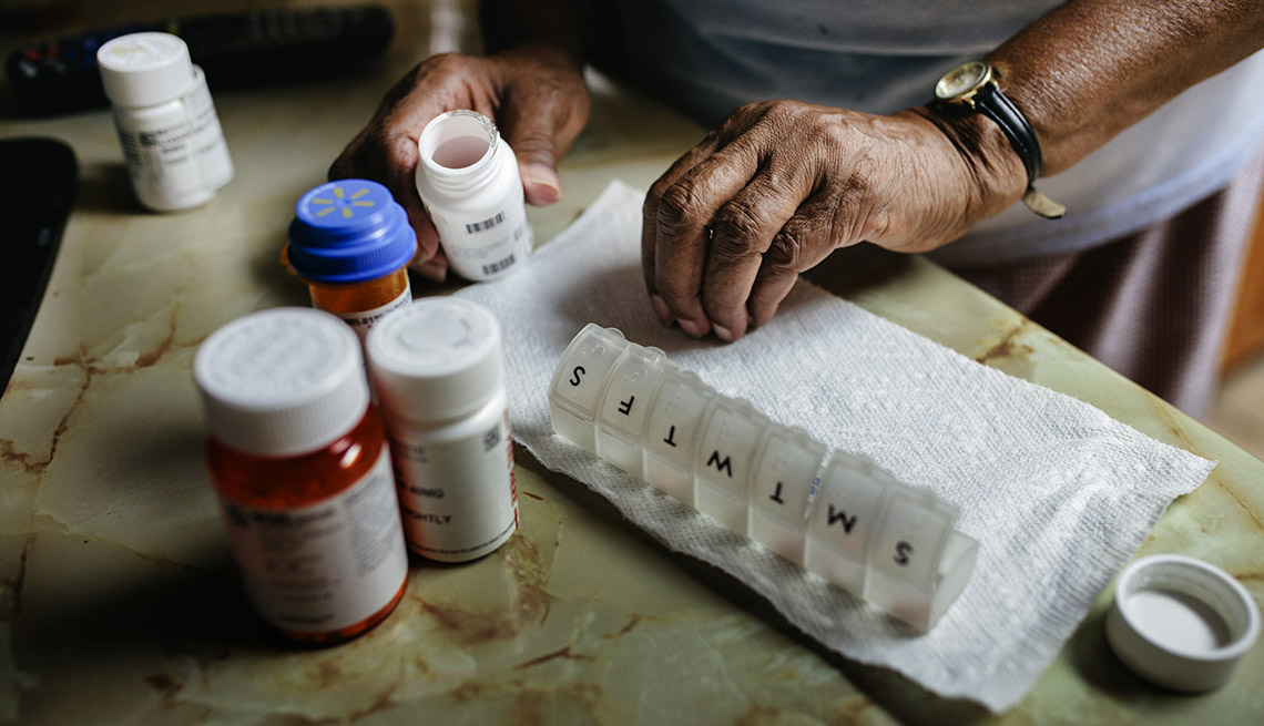 close-up of person sort medications