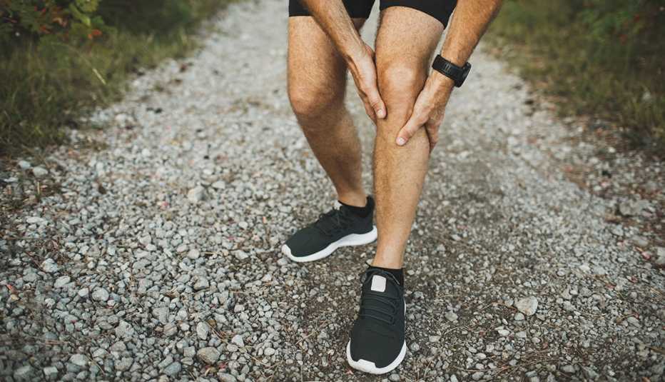 man rubbing knee to relieve joint pain