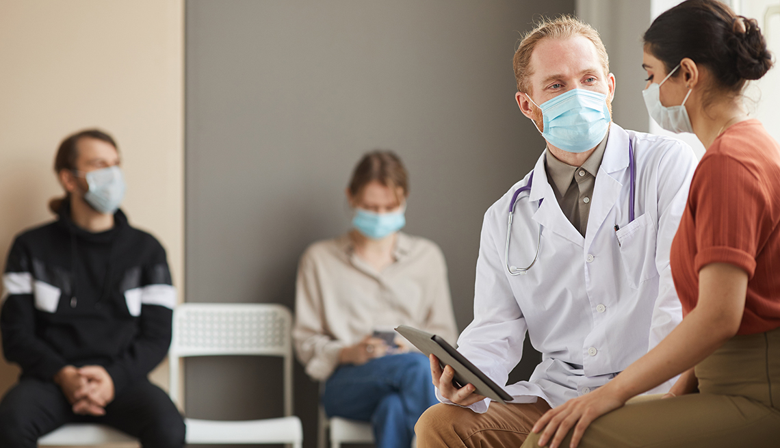 Medical provider talking to a patient in a waiting room