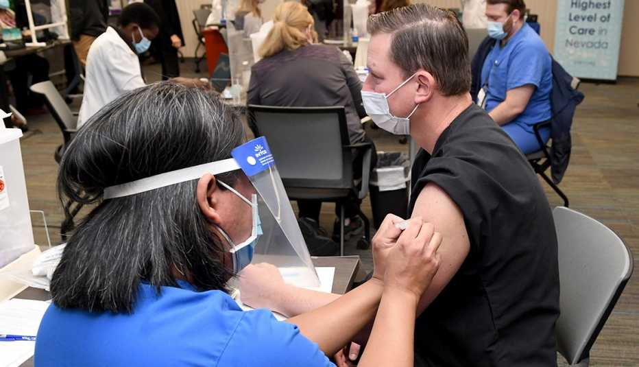 A medical provider receives a Pfizer-BioNTech COVID-19 vaccination. (Photo by Ethan Miller/Getty Images) A medical provider receives a Pfizer-BioNTech COVID-19 vaccination. (Photo by Ethan Miller/Getty Images)