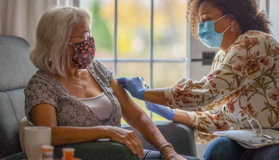 Woman getting a COVID vaccination at home.