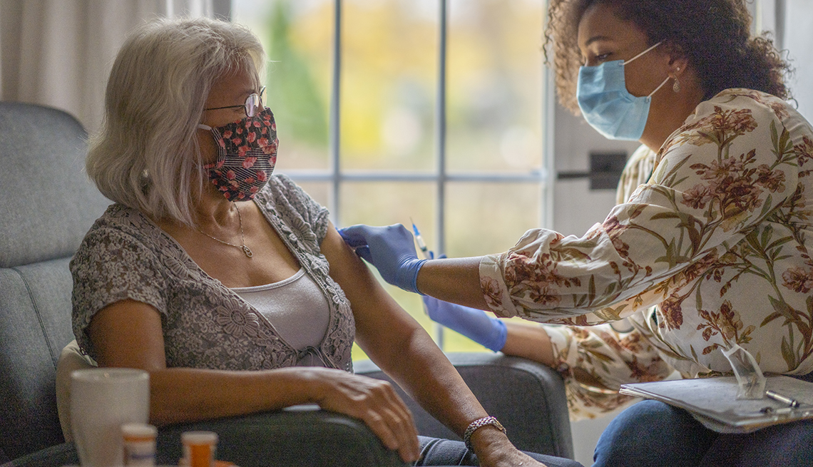 Woman getting a COVID vaccination at home.