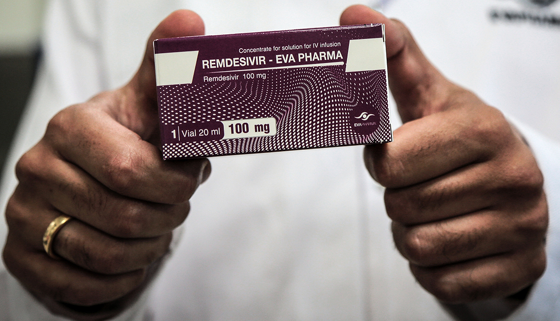 a person holds a pack containing vials of Remdesivir