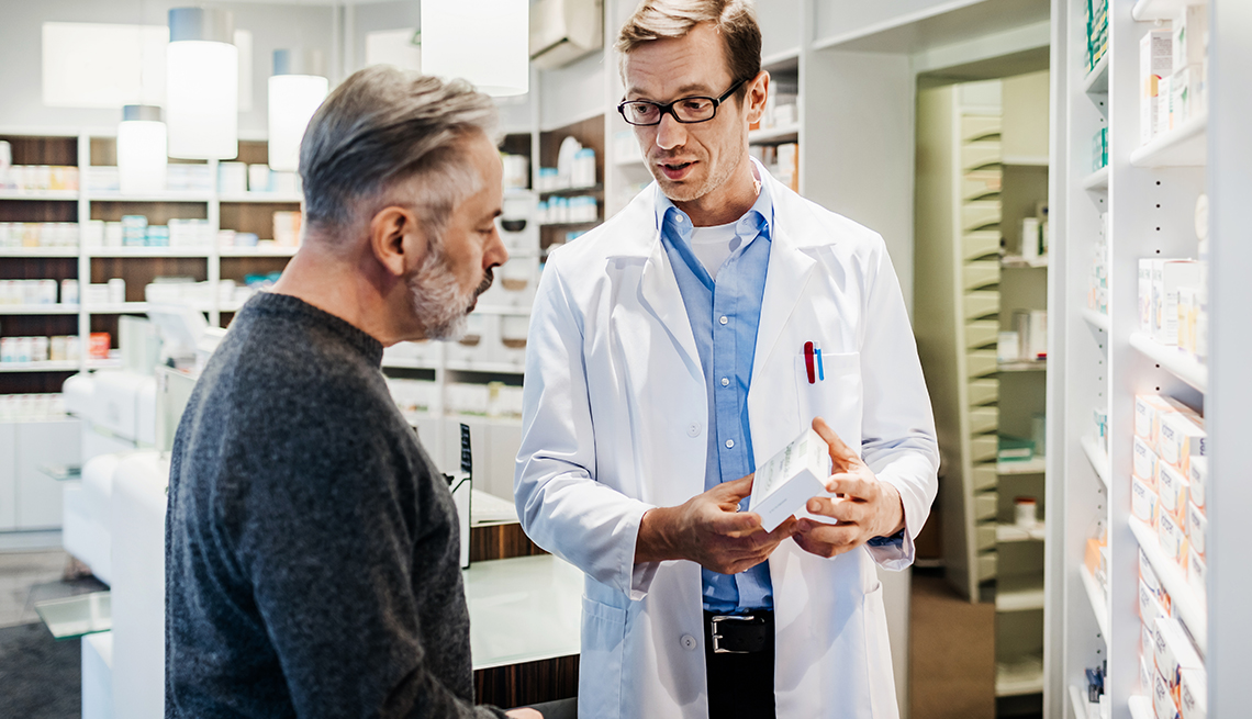 A pharmacist advising a customer 
