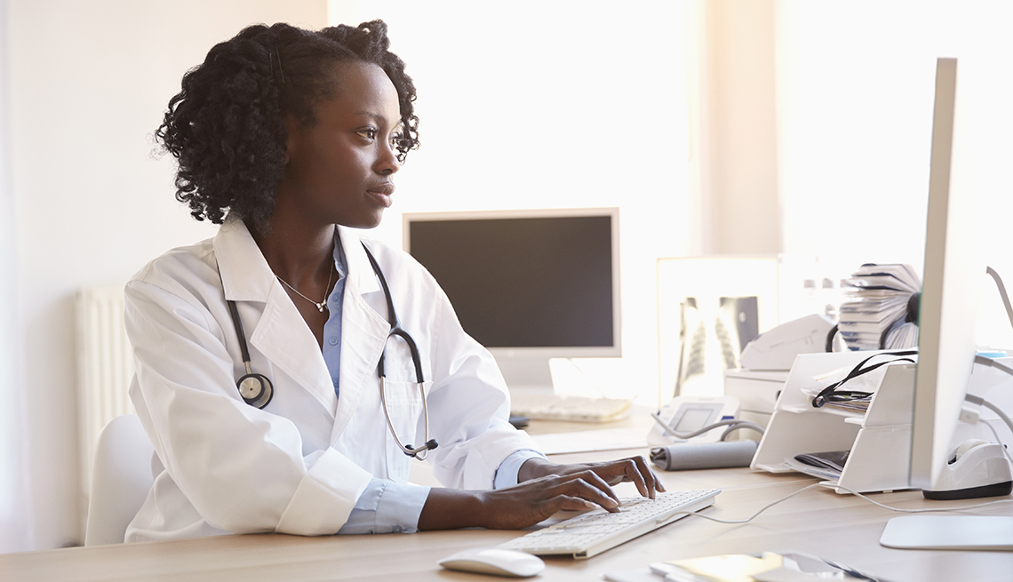 Doctor typing on her computer.
