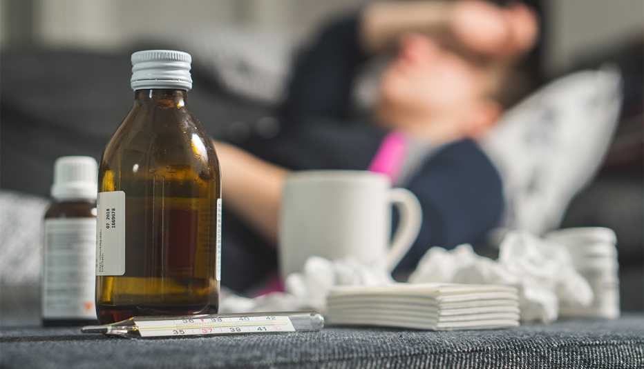 bedside table with cold and flu remedies and tissues