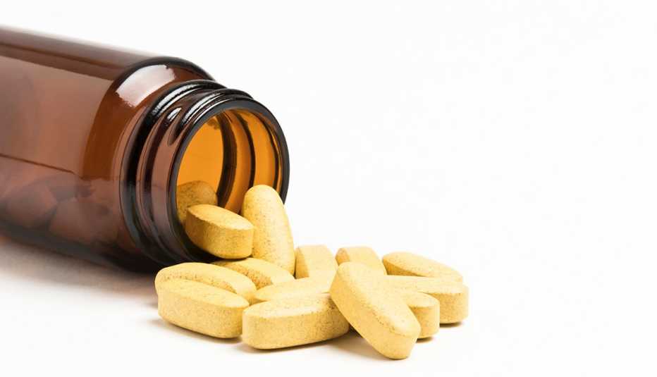 Pills spilling out of a bottle