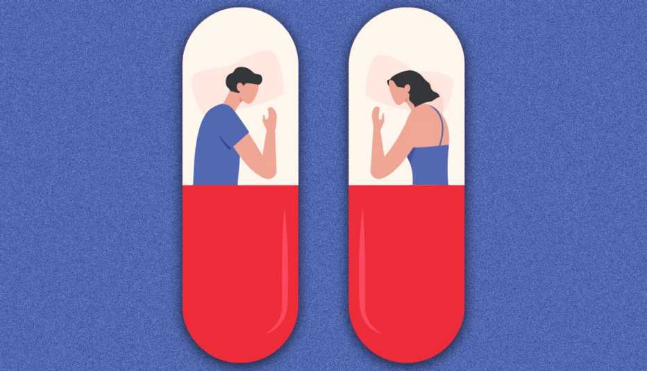 couple in two beds next to each other. The beds are shaped like sleeping pills