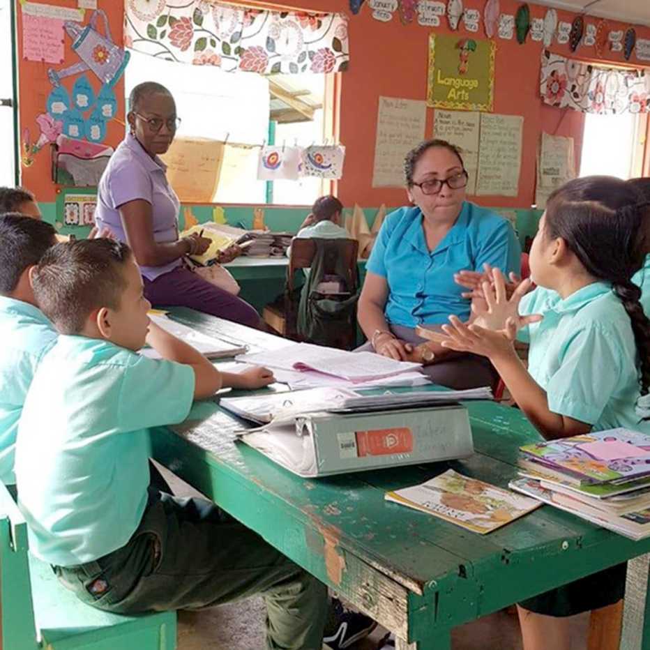 judith jones and another volunteer teaching children in a classroom while in the peace corps