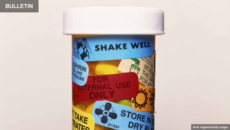 A prescription bottle with warning labels on it