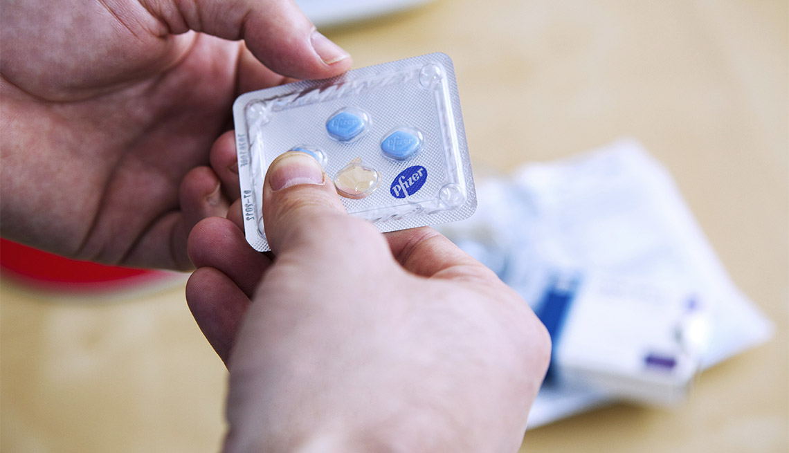 Man with Viagra pills