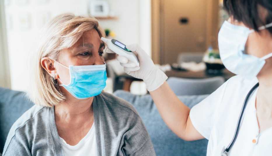 female patient getting her temperature taken