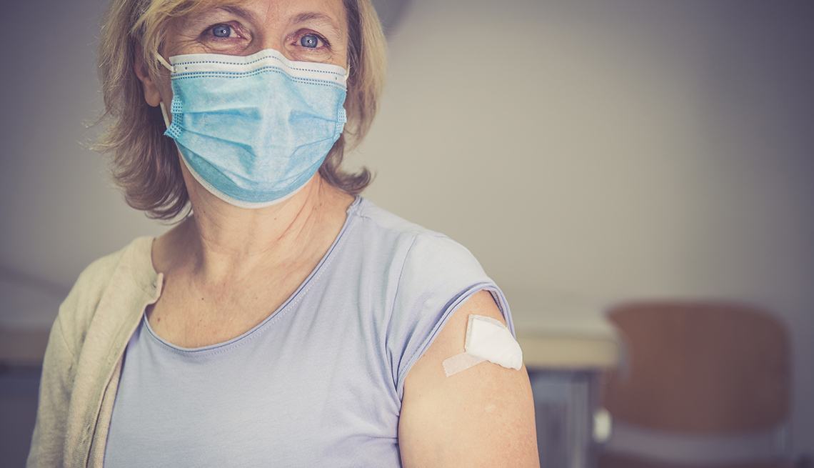 Woman who has just been vaccinated, wearing a face mask