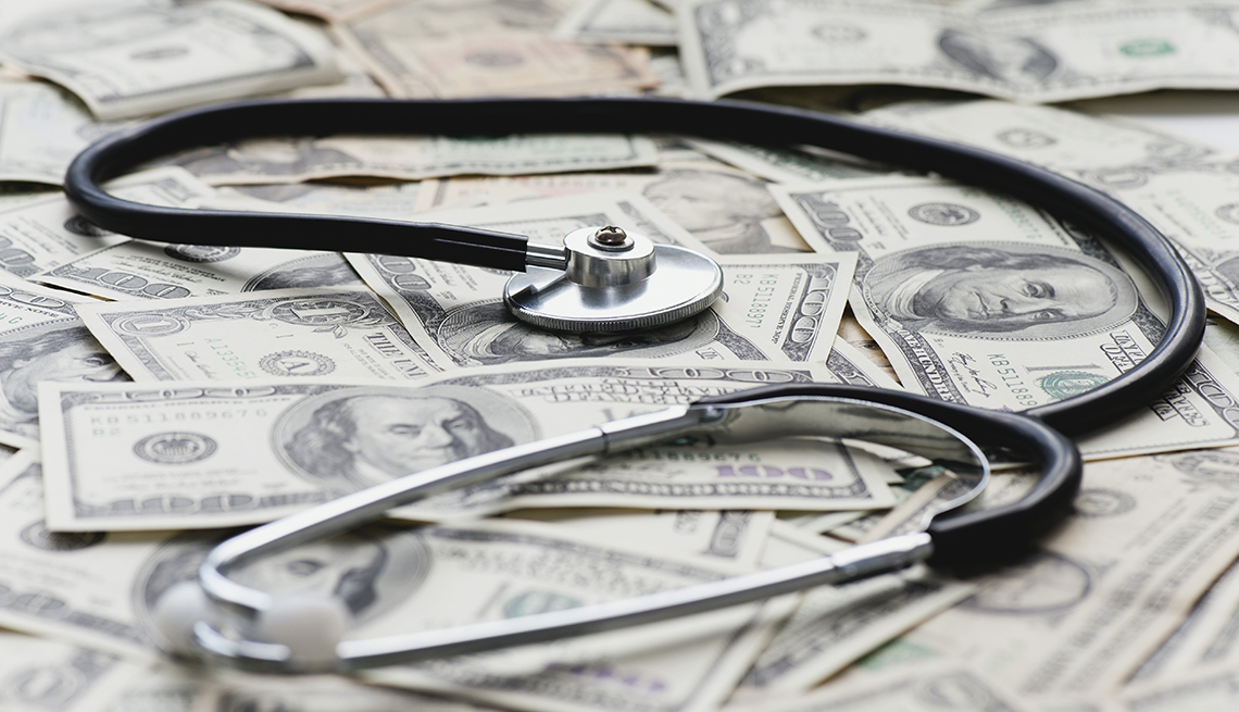 A stethoscope on top of money. 