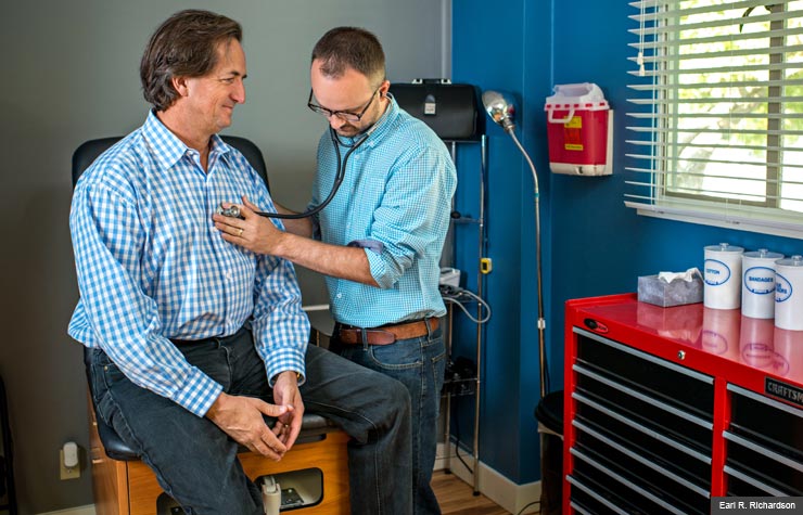Dr. Neuhofel, 32, conducts an exam on Bryan Welch, 54 (Earl R. Richardson) Dr. Neuhofel, 32, conducts an exam on Bryan Welch, 54 (Earl R. Richardson)