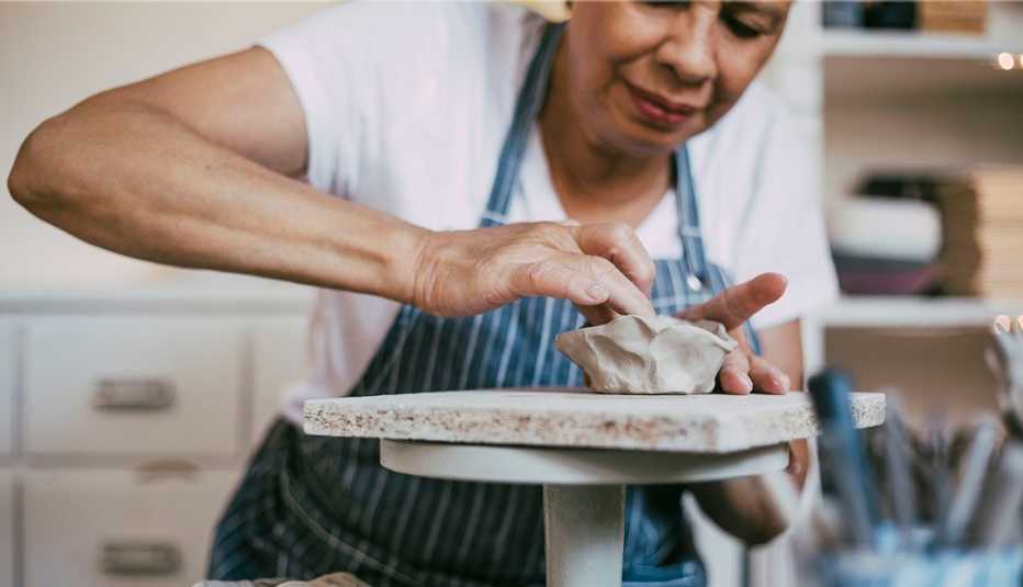 woman making a clay pot