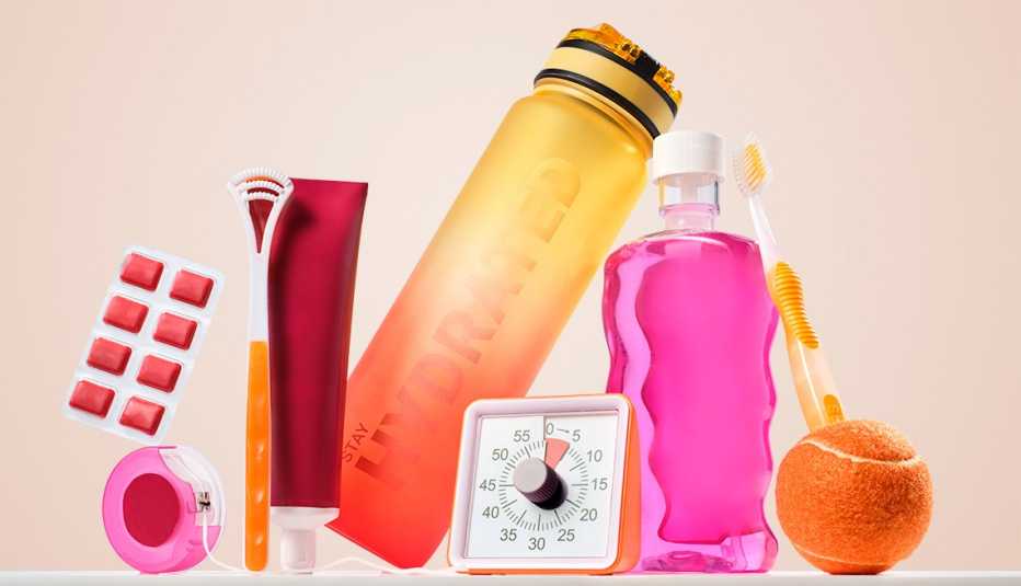 items related to dental health including a tooth brush toothpaste mouthwash a timer dental floss and a tongue scraper