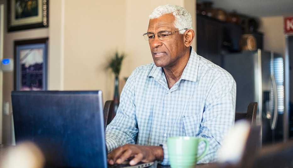 a man works on his computer at home