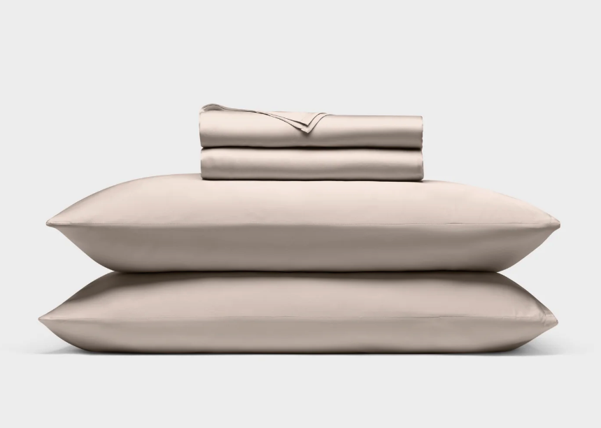 The Cozy Earth Bamboo Sheet Set stacked with pillows.