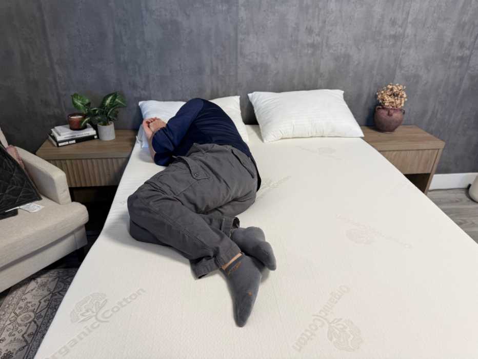 A man lying on his side on the Brooklyn bedding 3 Inch Latex Topper